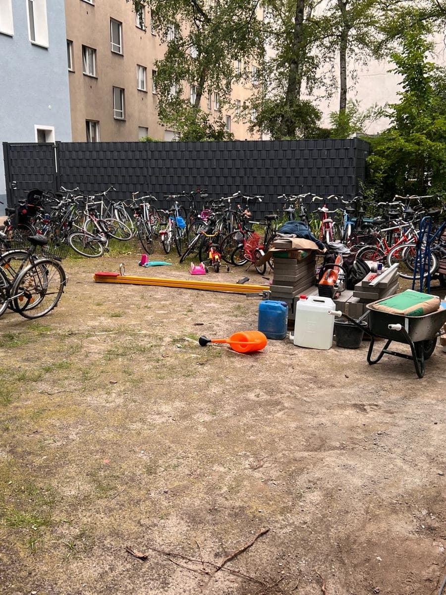Vollgestellter Hinterhof mit abgestellten Fahrrädern und Gerümpel